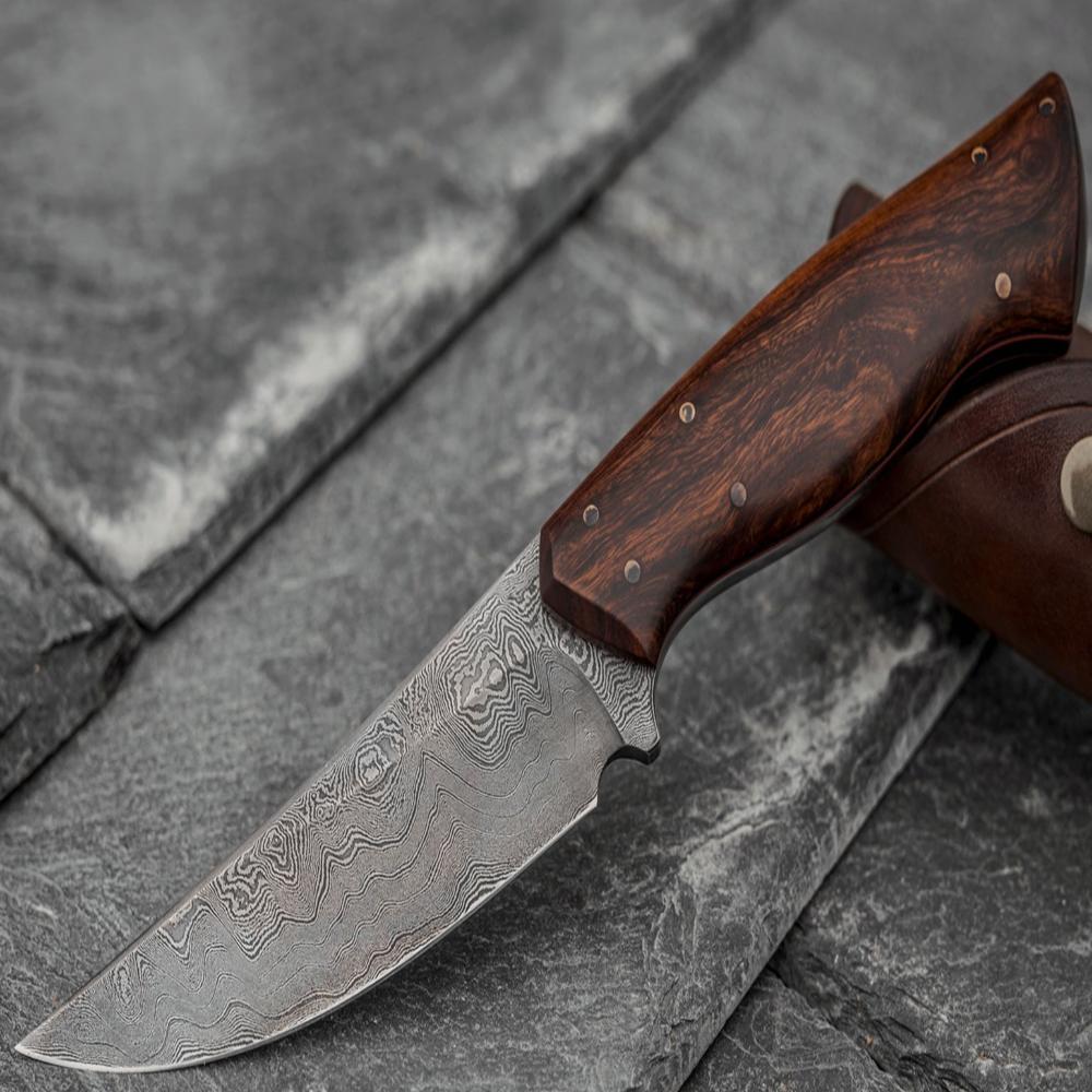 Custom made Bear's Claw shaped knife. Handforged carbon steel Damascus blade