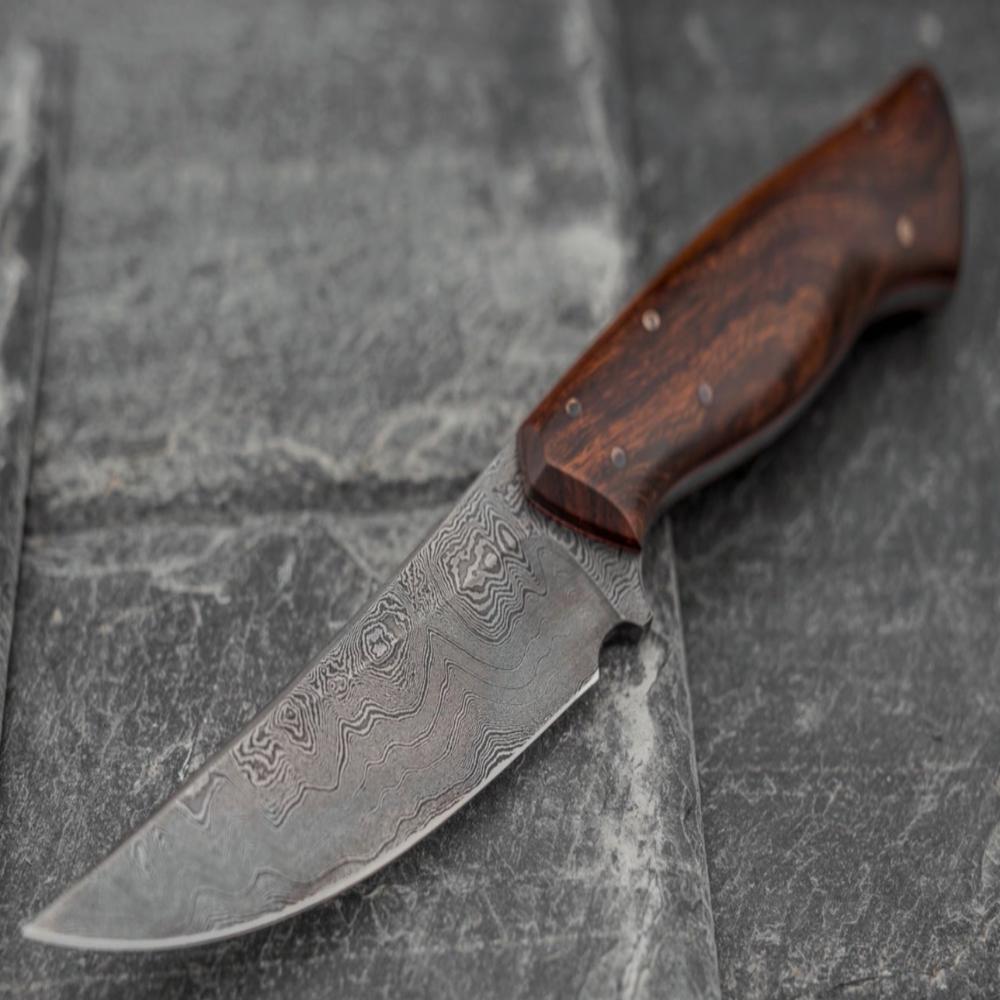 Custom made Bear's Claw shaped knife. Handforged carbon steel Damascus blade