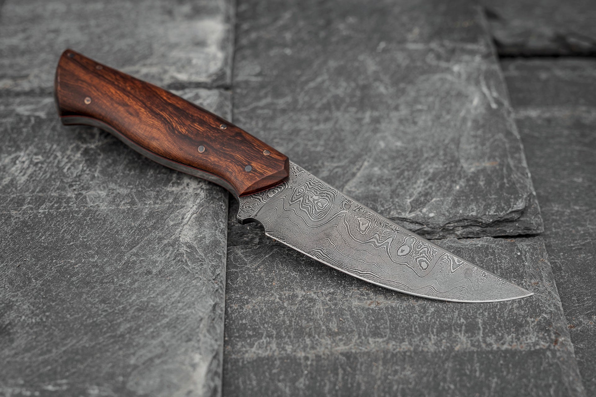 Custom made Bear's Claw shaped knife. Handforged carbon steel Damascus blade