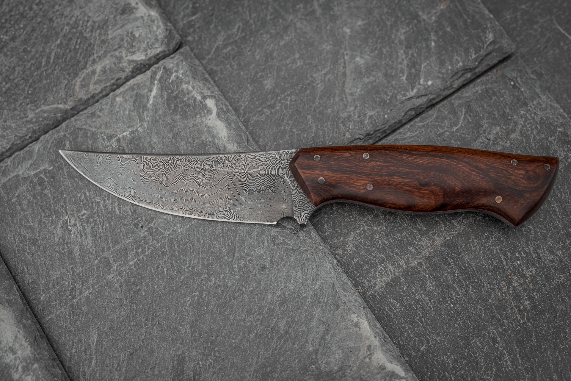 Custom made Bear's Claw shaped knife. Handforged carbon steel Damascus blade