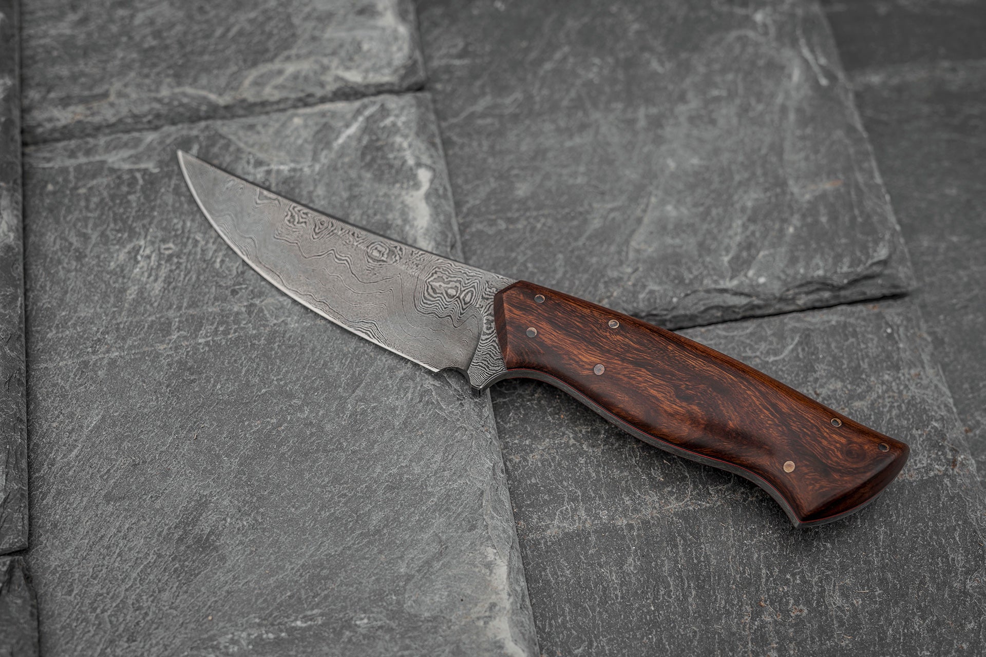 Custom made Bear's Claw shaped knife. Handforged carbon steel Damascus blade